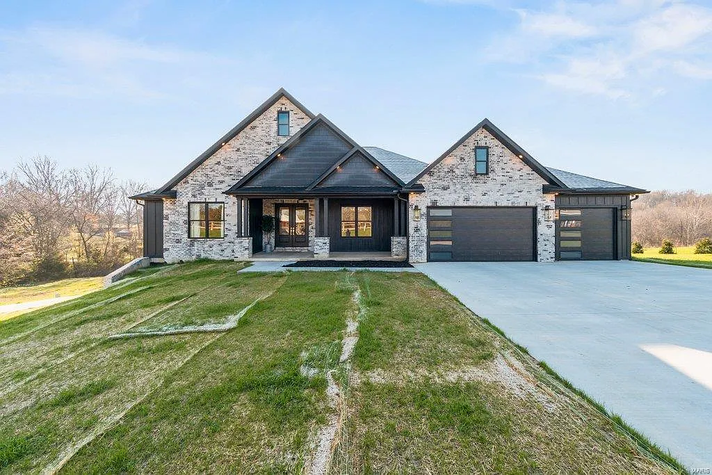 a house with a driveway and grass